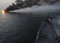 U.S. Navy sailors aboard USS William P. Lawrence prepare to provide rescue assistance to a burning vessel while transiting the Strait of Hormuz.