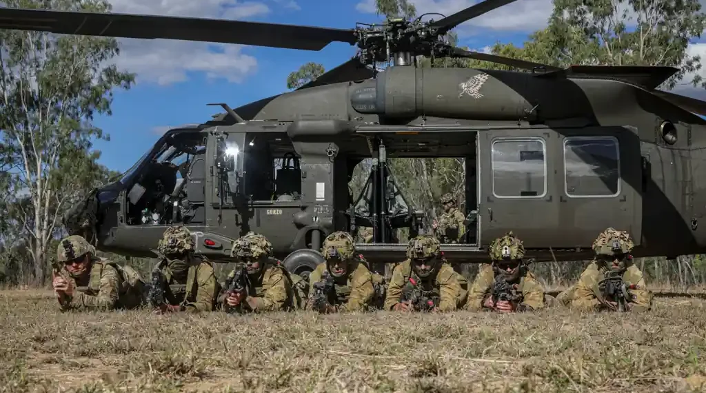 Australian Defence Force soldiers pose beside a UH-60 Black Hawk after combined training during Exercise Talisman Sabre in Townsville, Queensland.