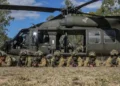 Australian Defence Force soldiers pose beside a UH-60 Black Hawk after combined training during Exercise Talisman Sabre in Townsville, Queensland.