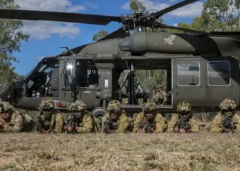 Australian Defence Force soldiers pose beside a UH-60 Black Hawk after combined training during Exercise Talisman Sabre in Townsville, Queensland.