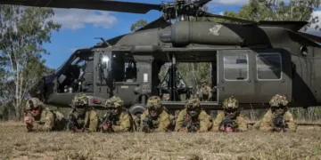 Australian Defence Force soldiers pose beside a UH-60 Black Hawk after combined training during Exercise Talisman Sabre in Townsville, Queensland.