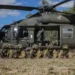 Australian Defence Force soldiers pose beside a UH-60 Black Hawk after combined training during Exercise Talisman Sabre in Townsville, Queensland.