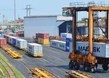 Straddle carrier moves a shipping container at Chattogram Port in Bangladesh during cargo handling operations.
