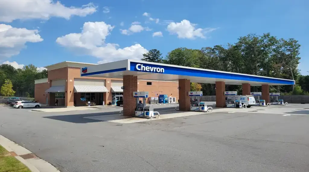 Chevron Super gas station sign and roadside fuel station visible in Sutallee, Georgia, United States.