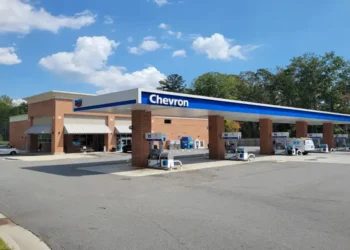 Chevron Super gas station sign and roadside fuel station visible in Sutallee, Georgia, United States.