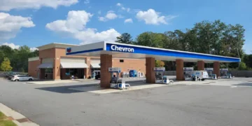 Chevron Super gas station sign and roadside fuel station visible in Sutallee, Georgia, United States.