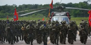 Colombian soldiers from the National Army Special Anti-drug Brigade move into position during an award ceremony in Larandia, Colombia.
