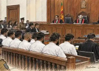 Courtroom hearing shows judges seated at the bench, defendants facing forward, lawyers and police officers present during proceedings.