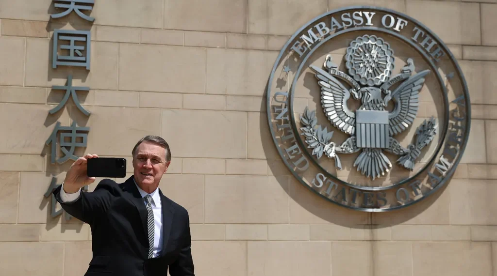 U.S. Ambassador to China David Perdue takes a selfie before the Great Seal at the U.S. Embassy in Beijing on May 15, 2025.
