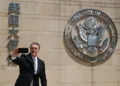 U.S. Ambassador to China David Perdue takes a selfie before the Great Seal at the U.S. Embassy in Beijing on May 15, 2025.