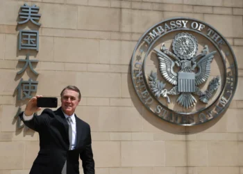 U.S. Ambassador to China David Perdue takes a selfie before the Great Seal at the U.S. Embassy in Beijing on May 15, 2025.