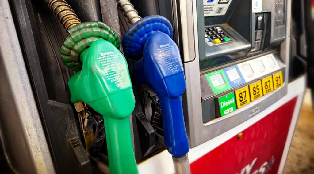 Diesel fuel pump at a gas station displaying fueling equipment and pricing information.