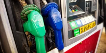 Diesel fuel pump at a gas station displaying fueling equipment and pricing information.