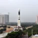 GSLV-F08 rocket stands on a mobile launch pedestal with the Vehicle Assembly Building visible behind it at an ISRO launch complex.