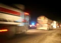 Iraqi fuel trucks convoy out of Camp Taji as Marines prepare vehicles for a mission to the Baiji Oil Refinery in Iraq.