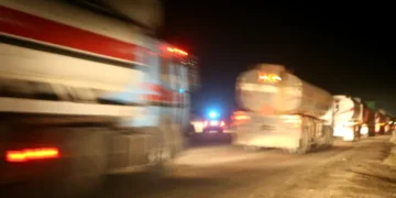 Iraqi fuel trucks convoy out of Camp Taji as Marines prepare vehicles for a mission to the Baiji Oil Refinery in Iraq.