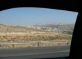Two Israeli settlements are visible on hills in the West Bank, viewed from a Palestinian road during a 2008 journey.