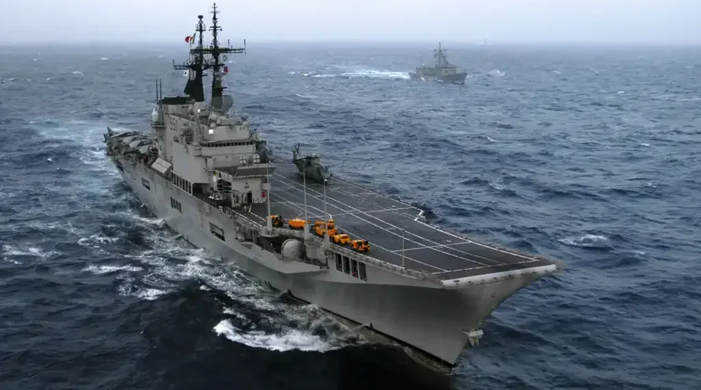Italian aircraft carrier ITS Giuseppe Garibaldi and Turkish frigate TCG Gediz sail through the Atlantic Ocean during Majestic Eagle 2004.