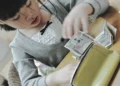 Child in Japan counting money received as New Year’s gift at home in Sapporo, Hokkaido.