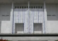 John F. Kennedy Center for the Performing Arts in Washington, D.C., with its exterior name partially covered by white scaffolding sheeting.