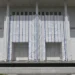 John F. Kennedy Center for the Performing Arts in Washington, D.C., with its exterior name partially covered by white scaffolding sheeting.