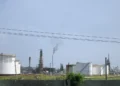 Oil refinery near Regla in Havana, Cuba, viewed from the surrounding area with industrial processing structures visible.
