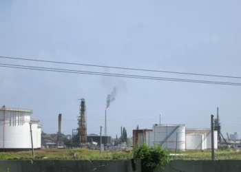 Oil refinery near Regla in Havana, Cuba, viewed from the surrounding area with industrial processing structures visible.