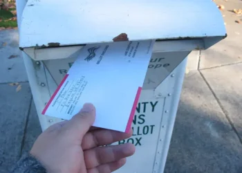 Voter returns a vote-by-mail ballot at a ballot return box in Lane County, Oregon, during the 2006 general election.