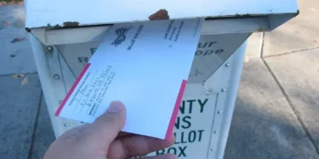 Voter returns a vote-by-mail ballot at a ballot return box in Lane County, Oregon, during the 2006 general election.