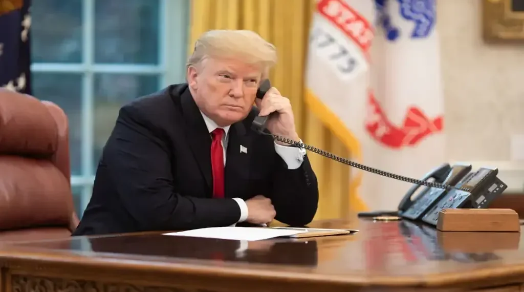 U.S. president speaks on the phone in the Oval Office while receiving an update about devastating California wildfires in November 2018.