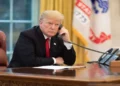 U.S. president speaks on the phone in the Oval Office while receiving an update about devastating California wildfires in November 2018.