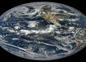 Satellite view of tropical cyclones Lowell, Karina and Marie swirling over the Pacific Ocean west of Central America.
