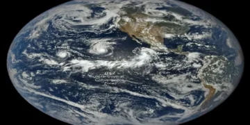 Satellite view of tropical cyclones Lowell, Karina and Marie swirling over the Pacific Ocean west of Central America.