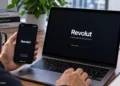 Revolut financial app displayed on a smartphone and laptop during digital finance use at a desk