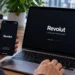 Revolut financial app displayed on a smartphone and laptop during digital finance use at a desk