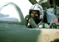 Royal Saudi Arabian Air Force pilot adjusts an oxygen mask inside an F-5 Tiger II cockpit before a training mission in 1982.