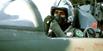 Royal Saudi Arabian Air Force pilot adjusts an oxygen mask inside an F-5 Tiger II cockpit before a training mission in 1982.