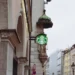 Starbucks siren sign stands before an Archangel Michael statue on Sendlinger Straße in Munich, Germany.