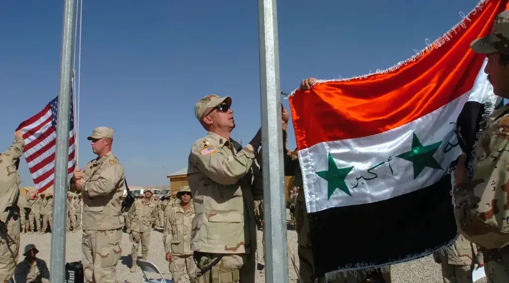 U.S. and Iraqi Army soldiers observe Veterans Day at Forward Operating Base Sykes in Tall Afar, Iraq, on November 11, 2005.