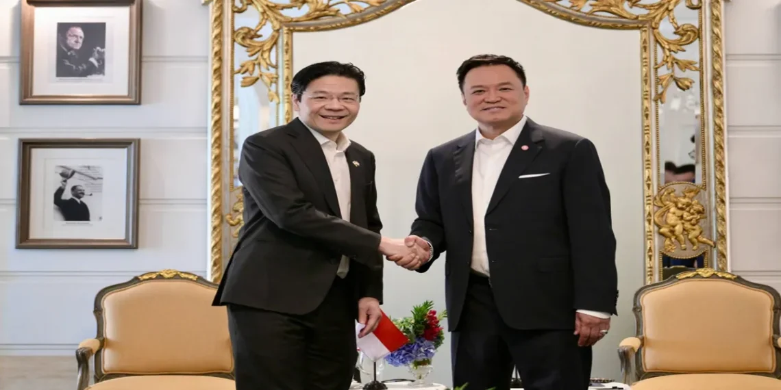 Two prime ministers shake hands during the Thailand–Singapore Leaders’ Retreat at a government venue in Bangkok.