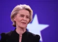 Ursula von der Leyen stands at a podium during a European ceremony honoring former Commission President Jacques Delors in Brussels.