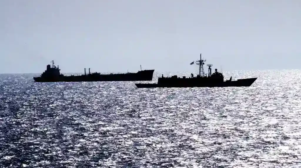 Guided missile frigate USS RENTZ escorts transport oiler USS SEALIFT CHINA SEA through the Strait of Hormuz on October 1, 1987.