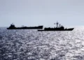 Guided missile frigate USS RENTZ escorts transport oiler USS SEALIFT CHINA SEA through the Strait of Hormuz on October 1, 1987.
