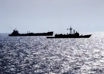 Guided missile frigate USS RENTZ escorts transport oiler USS SEALIFT CHINA SEA through the Strait of Hormuz on October 1, 1987.