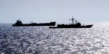 Guided missile frigate USS RENTZ escorts transport oiler USS SEALIFT CHINA SEA through the Strait of Hormuz on October 1, 1987.
