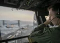 U.S. Navy officer oversees flight operations from USS Tripoli’s control tower as the amphibious assault ship sails in the Arabian Sea.