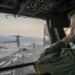U.S. Navy officer oversees flight operations from USS Tripoli’s control tower as the amphibious assault ship sails in the Arabian Sea.