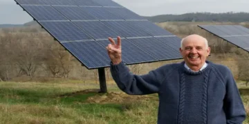 Wendell Berry stands beside solar panels on his farm in Henry County, Kentucky, in a photograph taken in 2011.
