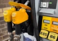 Yellow gasoline pump displaying E85, E15, and Eco Unleaded fuel options at a service station.