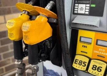 Yellow gasoline pump displaying E85, E15, and Eco Unleaded fuel options at a service station.